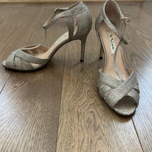 Nina gold sandals. T strap. Very comfortable.